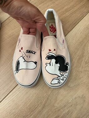 Vans women’s Pink Peanuts Slip-On Sneakers with Snoopy & Lucy Graphics